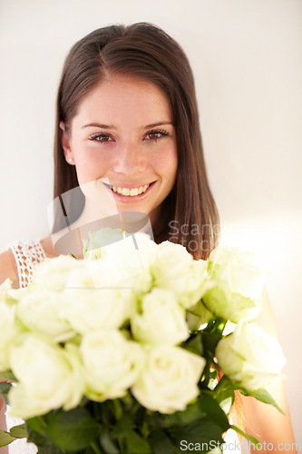 Image of Portrait, woman and white roses with beauty, smile and achievement for romance, happiness and excited. Face, man and woman with flower bouquet, celebration or floral gift for joy or romantic gesture