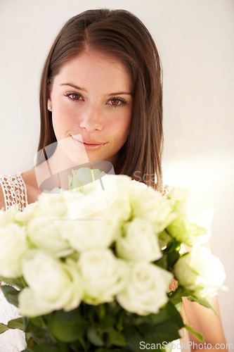 Image of Portrait, woman or white roses for love, gift or smile for Valentines day, happiness or joy for floral present on studio background. Face, female or lady with flowers, bouquet or cheerful on backdrop