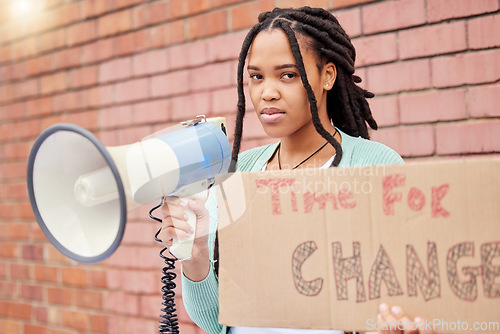 Image of Portrait, poster and woman on megaphone for change, protest or human rights on brick wall background. Billboard, speaker and face of girl for announcement of global, transformation or freedom mission