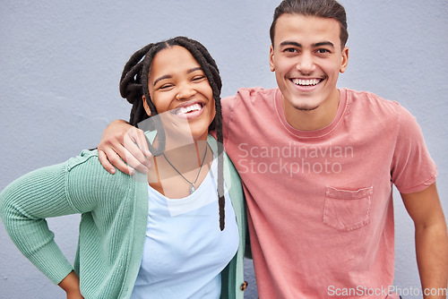 Image of Love, happy and portrait of a couple by a wall in the city while on a vacation or weekend trip. Happiness, smile and interracial man and woman embracing while walking in town on holiday or adventure.