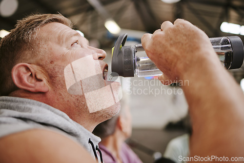 Image of Exercise, man and drinking water in gym, wellness and after training for goal, workout and fitness. Male, athlete and bottle for aqua, liquid and energy for practice, cardio and power with hydration