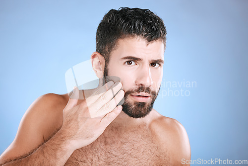Image of Skincare, beard grooming and portrait of man on blue background for beauty, wellness and salon. Luxury spa, dermatology and worried male check face for healthy skin, blackhead and facial hair growth