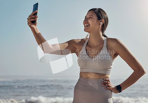 Image of Fitness, selfie and woman at the beach for yoga, training and workout on blue sky background. Social media, live streaming and exercise influencer female recording for blog, post or profile picture