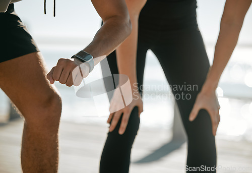 Image of Running couple, time and smartwatch with fitness and check heart rate with cardio and outdoor workout. Legs, hands and cardiology with runner black man and woman, exercise and wellness with run break