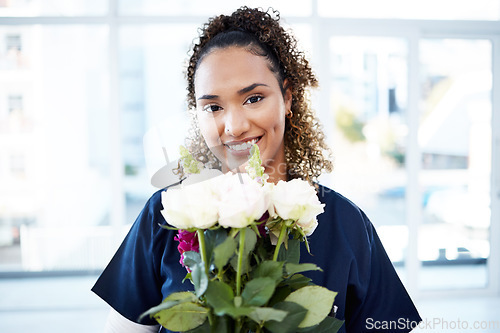 Image of Happy, portrait and woman nurse with flowers for valentines day, romance or anniversary in the hospital. Happiness, smile and female healthcare worker with a floral bouquet of roses in the clinic.