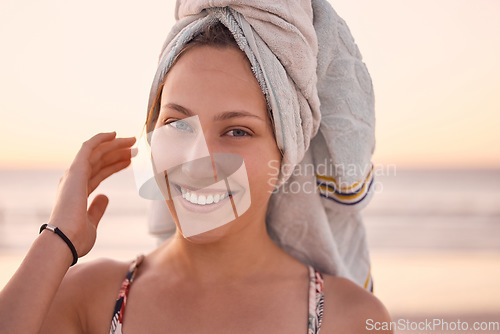 Image of Woman, portrait and towel on head at beach, summer vacation or tropical holiday in Australia. Face, happy female and relax at ocean with wet hair cloth, smile or freedom of happiness at travel resort