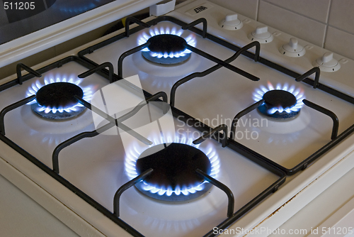 Image of Four blue flames of a gas stove
