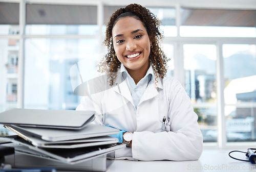 Image of Doctor, documents and portrait of healthcare professional with paperwork on desk or table in the office smile and happy. Medical, research and medicine student studying and learning for knowledge