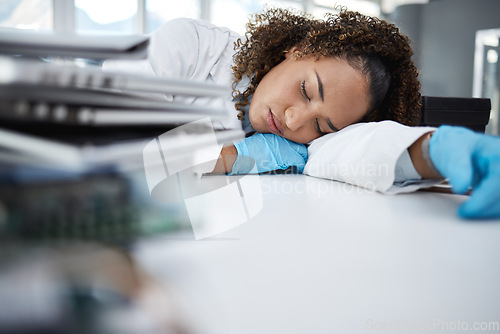 Image of Science, exhausted and scientist taking nap in lab after working on innovation experiment, test or research. Tired, burnout and professional female scientific employee sleeping on desk in laboratory.