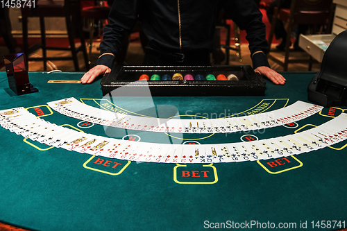 Image of Professional croupier during cards