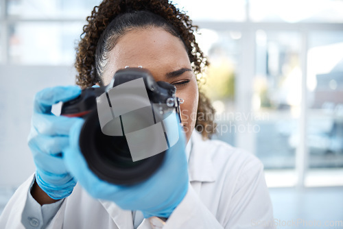 Image of Camera, medical and forensics with black woman in laboratory for investigation, crime scene and photography evidence. Research, analytics and observation with girl and digital pictures for science