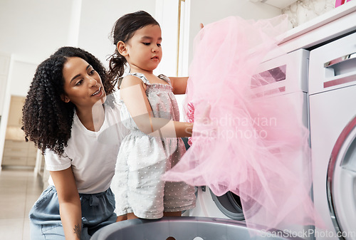 Image of Mom, girl child and teaching at washing machine with fabric, cloth or clothes in house with helping hand. Black woman, mother and daughter with laundry, learning or help for life skill in family home