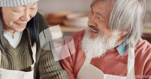 Image of Pottery, creative and senior couple talking about art with hug and kiss together in a studio class. Elderly Asian man and woman hugging with love while learning and working with clay on a date