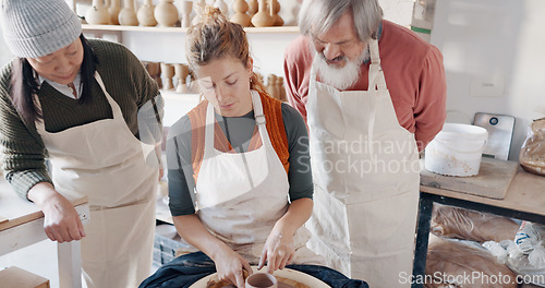 Image of Pottery, group and teacher mold clay in studio or workshop learning with instructor woman, coach or trainer. Lesson, art and people practice hobby, arts or crafting handmade ceramic mug, cup or bowl