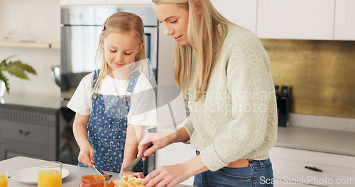 Image of Breakfast, morning and mother and kid cooking, help or prepare croissant meal, fruit or food in home kitchen. Love, happy family and youth girl with mom, mama or woman enjoy fun quality time and bond