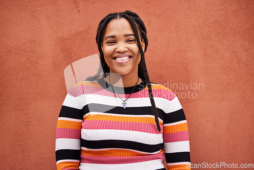 Image of Portrait, fashion and braids with a black woman on an orange background outdoor for style or empowerment. Style, wellness and profile picture with an african american person posing against a wall