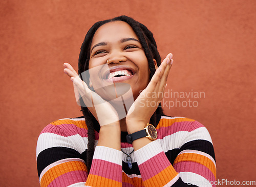 Image of Happy, laugh and freedom with a black woman on an orange background outdoor for joy or humor. Funny, laughter and smile with an african american person laughing or joking against a color wall