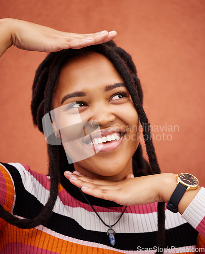 Image of Pose, happy and woman thinking with hands isolated on a brown studio background. Idea, frame and young girl smiling with happiness, thoughtful and playful while posing on a backdrop for fashion