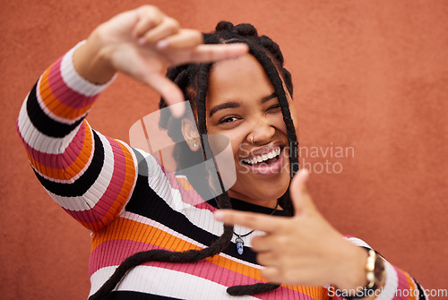 Image of Finger framing, portrait and black woman on background for profile picture in Nigeria. Face, happy female and hands frame perspective, selfie and vision of happiness, smile and photography in studio