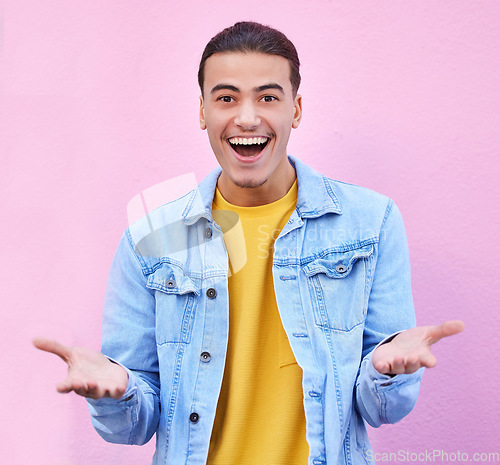 Image of Man, portrait and wall with open hands, smile and excited wow for fashion, vision and success in city. Young gen z student, trendy clothes and surprise with happiness by pink background in metro