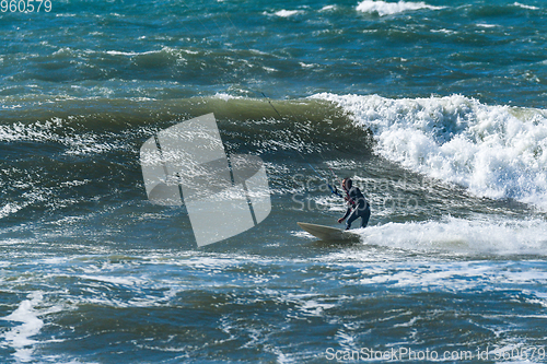 Image of Kitesurfer riding ocean waves