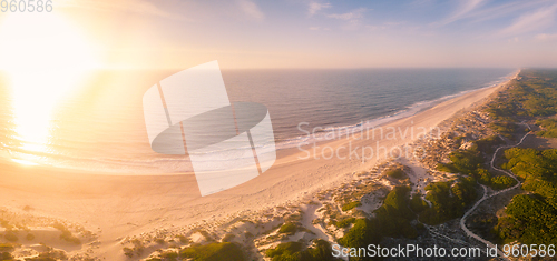 Image of Aerial view of beach at sunset