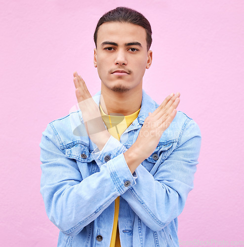 Image of No, stop and portrait of a man with hands as a sign isolated on a pink studio background. Angry, caution and serious person with a rejection, decline and problem gesture with arms on a backdrop