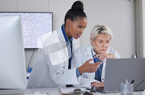 Image of Teamwork, laptop and doctors planning in laboratory for medical research for science. Cooperation, collaboration and researchers, black woman and senior female helping, discussion or brainstorming.