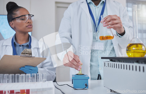 Image of Science, laboratory and team with liquid in test tube for medical research, study and vaccine development. Biotechnology, pharmaceutical and scientists with sample for analysis, test and experiment