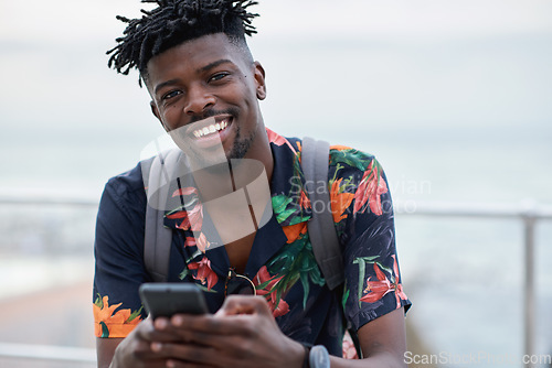 Image of Black man, travel and portrait with smartphone and outdoor with communication, adventure at beach and backpacking. Holiday, happy and chat, check social media or post with 5g, technology and vacation