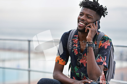 Image of Phone call, communication and black man with a cellphone in the city while on an adventure. Happy, smile and African male on a mobile conversation with smartphone in town on a holiday or weekend trip