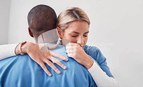 Image of Comfort, support and doctors hugging in the hospital after the death of a patient in surgery. Healthcare, sad and medical workers embracing with care, love and compassion in the medicare clinic.