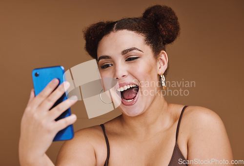Image of Phone, selfie and face of woman with smile on brown background for wellness, fashion and makeup. Wow, video call and happy girl influencer on smartphone for social media, internet and online post
