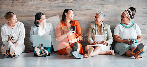 Image of Collaboration, technology and communication with a business team sitting on the floor in their office for work. Teamwork, diversity and corporate design with a woman employee group working together