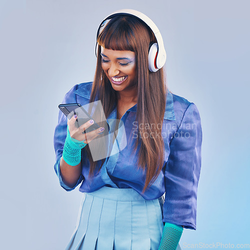 Image of Phone, music and fashion with a model black woman in studio on a gray background for contemporary style. Social media, happy and edgy with a trendy person streaming or listening to audio inside