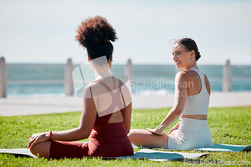 Image of Yoga, park and young couple of friends or women for zen fitness, exercise and mindfulness, healing and support. Pilates training, workout people talking of health and body wellness together at beach