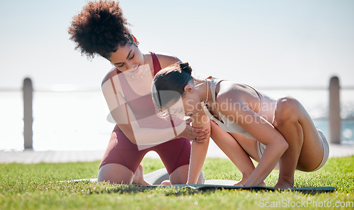 Image of Yoga class, personal trainer or women support, helping and learning balance, training and exercise on beach or park. Coaching black woman with pilates workout on grass for sports and body wellness