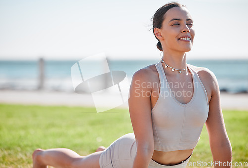 Image of Yoga, wellness and woman stretching on grass for healthy lifestyle, pilates training and cardio workout. Sports, balance and happy girl doing meditation, cobra stretch and exercise for mindfulness