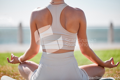 Image of Yoga, lotus pose and woman from behind in park or beach for zen fitness, exercise and mindfulness, healing and peace. Meditation, nature and calm person with mental health in nature for body wellness