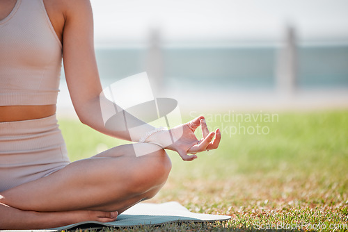 Image of Yoga, lotus hand and woman in park or beach for zen fitness, exercise and mindfulness, healing and peace. Meditation, nature and calm person with mental health, holistic training for body wellness