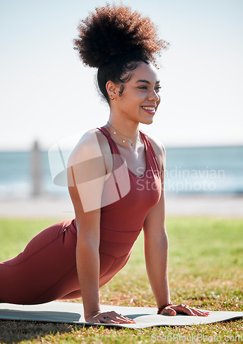 Image of Yoga, pilates and black woman stretching on grass for healthy lifestyle, body wellness and cardio workout. Sports, fitness and girl doing meditation training, cobra stretch and exercise for peace