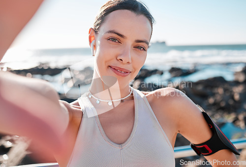 Image of Fitness, woman and portrait smile for selfie, vlog or profile picture by beach for running exercise. Happy female runner smiling for social media, memory or post by ocean coast for healthy wellness