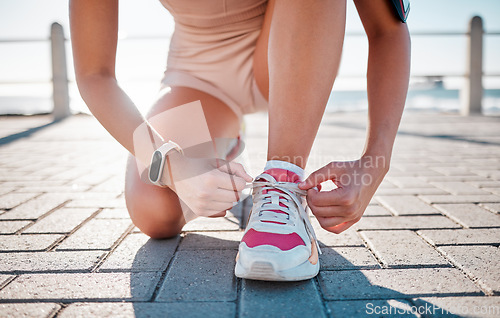 Image of Closeup, fitness and woman tie shoes, training and exercise for wellness, health and performance. Zoom, female athlete and lady with tying shoes, ready for marathon and run for cardio and energy