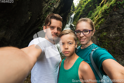 Image of Selfie of family on the waterfall background