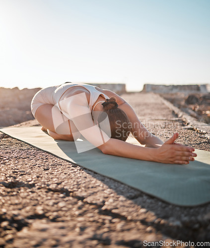 Image of Yoga, pilates and woman stretching on rock for healthy lifestyle, body wellness and cardio workout. Sports, training and girl do meditation, stretch arms and exercise for zen, peace and calm outdoors