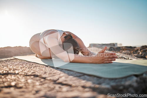 Image of Exercise, yoga and woman stretching on rock for healthy lifestyle, body wellness and cardio workout. Sports, pilates training and girl do meditation, stretch and fitness for zen mindfulness outdoors