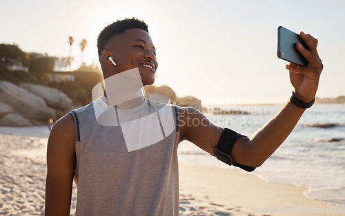 Image of Sports, fitness selfie and black man at beach for social media, video call or training blog update on running goals. Athlete, runner or african person with exercise, cardio or workout profile picture