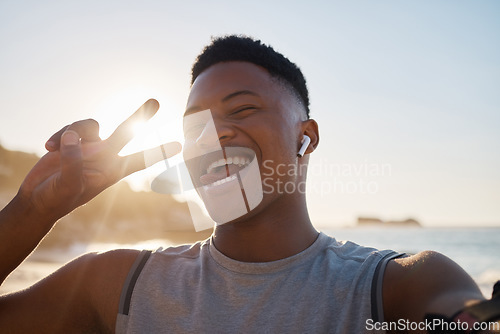Image of Selfie, fitness and peace with a black man on the beach for a cardio or endurance workout during summer. Portrait, hand sign and exercise with a male athlete or runner outdoor for marathon training