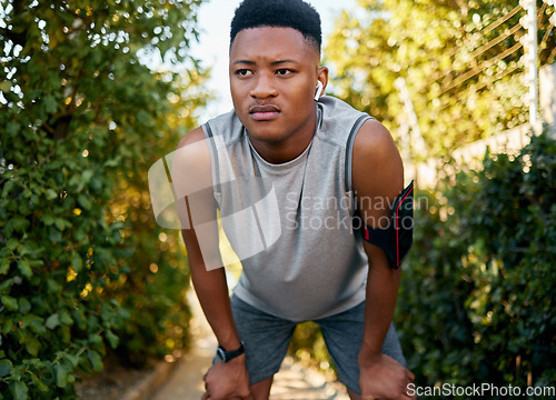 Image of Fitness, running and tired with a sports black man outdoor during summer taking a break from a workout. Exercise, health and exhausted with a male runner or athlete resting while training outside