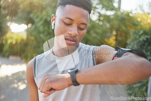 Image of Fitness, man and watch checking time or performance after running exercise, cardio workout or training in nature. Sporty male runner looking a wristwatch for tracking or monitoring healthy exercising